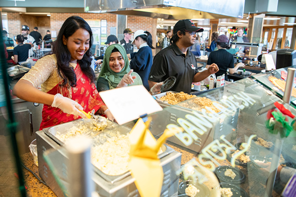 Dining service employees preparing to serve students
